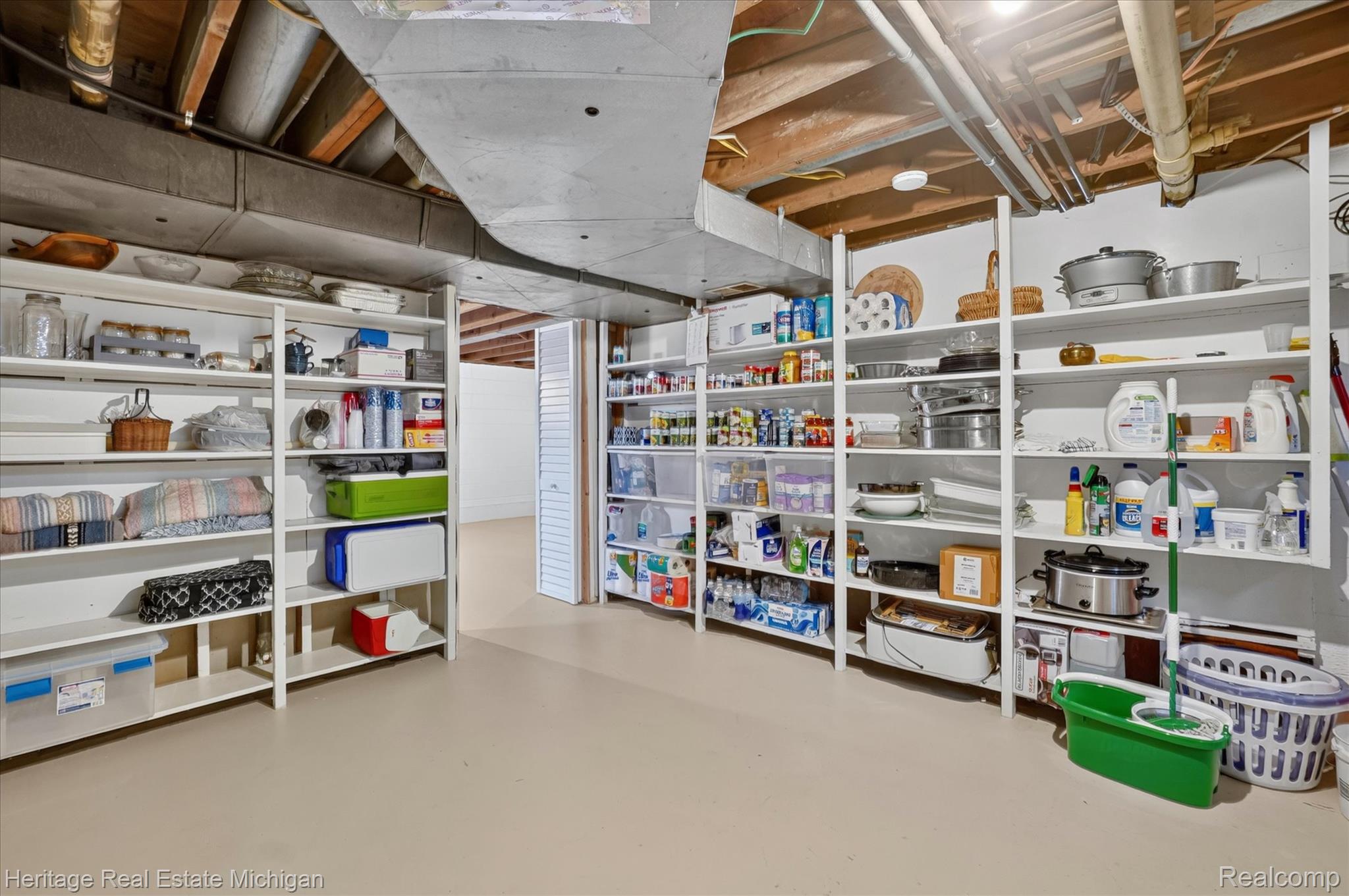 14038 North Hogan Road Linden, MI 48451 - Photo 38 of 53 Lower level storage area featuring multiple open shelving units