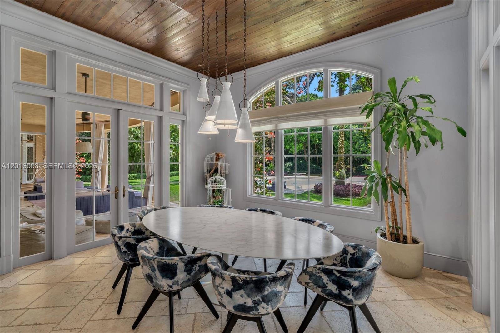4790 Southwest 78th Street Miami, FL 33143 - Photo 7 of 33 a view of a dining room with furniture a chandelier and a potted plant