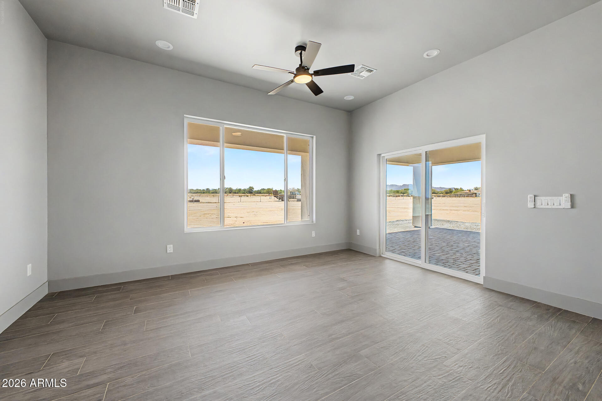 40461 West Robles Road Stanfield, AZ 85172 - Photo 30 of 54 an empty room with wooden floor and windows