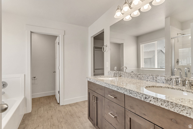 4572 Flower Point Eagle Mountain, UT 84005 - Photo 39 of 62 Bathroom featuring a dual vanity with granite countertop, wood-finish cabinetry, and undermount sinks