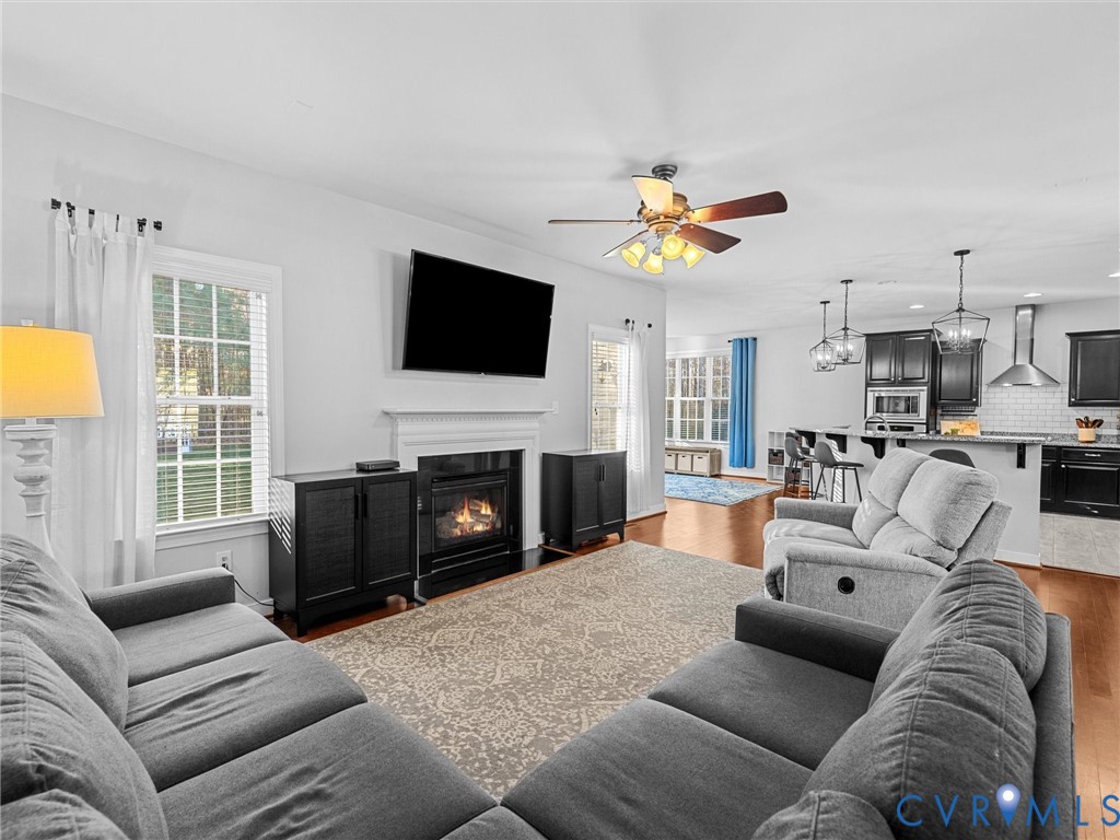 16101 Longlands Road Chesterfield, VA 23832 - Photo 11 of 48 a living room with furniture a fireplace and a flat screen tv