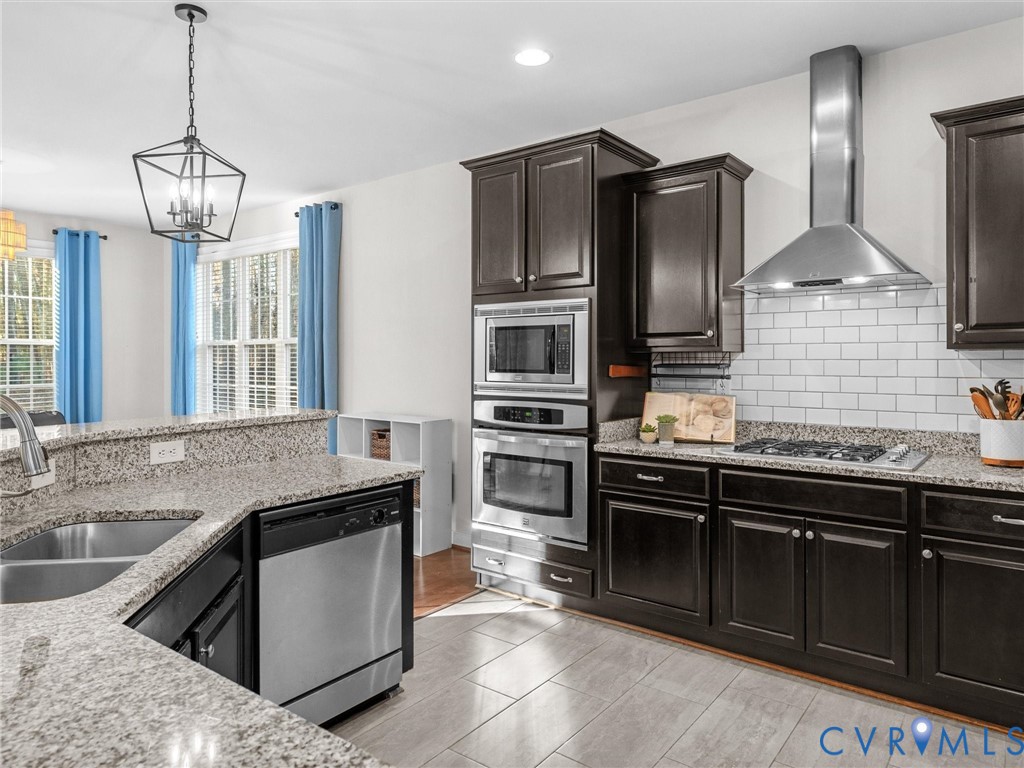 16101 Longlands Road Chesterfield, VA 23832 - Photo 12 of 48 a kitchen with stainless steel appliances granite countertop a sink stove and refrigerator
