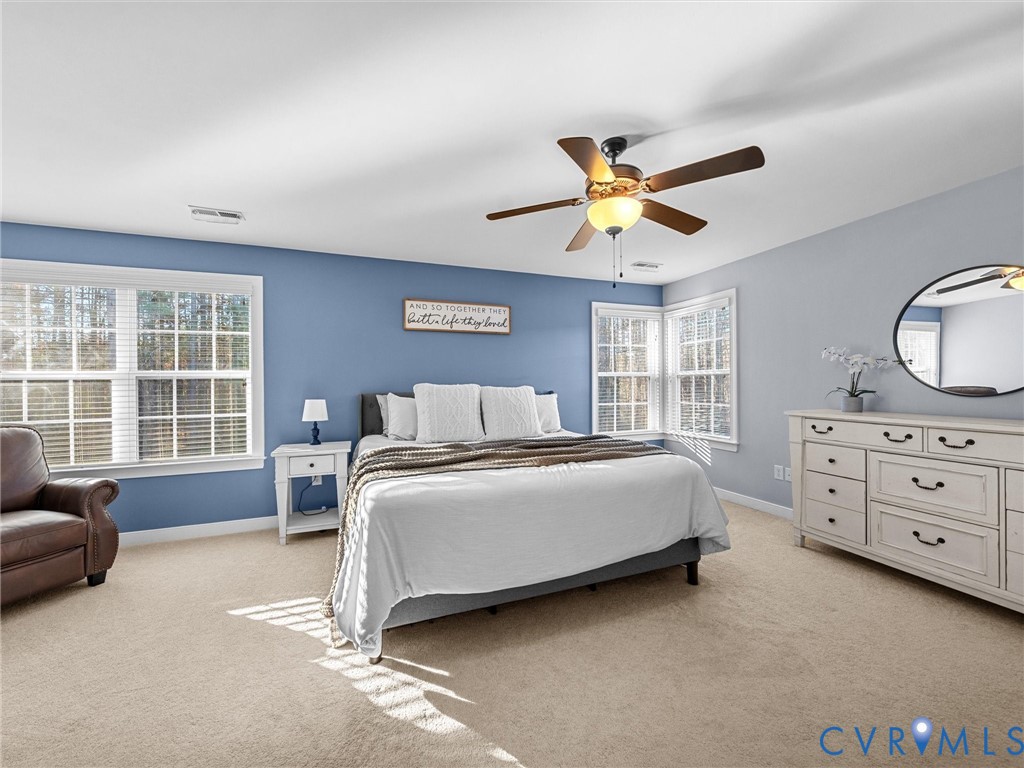 16101 Longlands Road Chesterfield, VA 23832 - Photo 17 of 48 a spacious bedroom with a bed a couch and a dresser next to a window