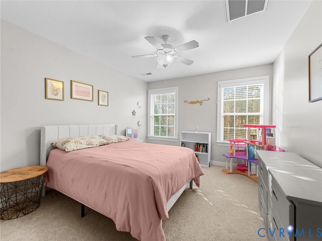 16101 Longlands Road Chesterfield, VA 23832 - Photo 23 of 48 a bedroom with a bed and a chandelier