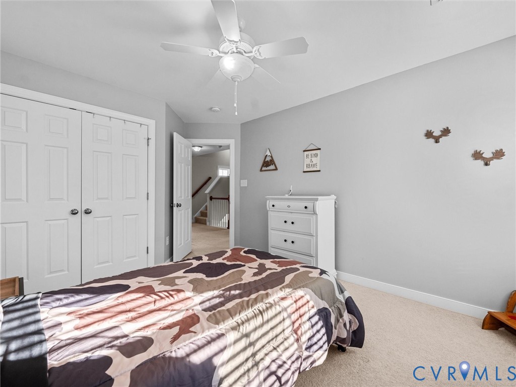 16101 Longlands Road Chesterfield, VA 23832 - Photo 29 of 48 a bedroom with a bed and a chandelier