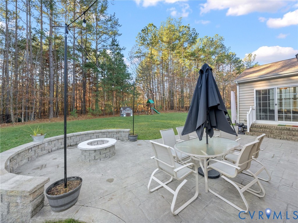 16101 Longlands Road Chesterfield, VA 23832 - Photo 35 of 48 a view of a table and chairs in backyard