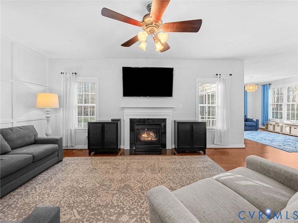 16101 Longlands Road Chesterfield, VA 23832 - Photo 10 of 48 a living room with furniture a flat screen tv and a fireplace