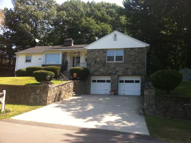 a front view of a house with yard and garage