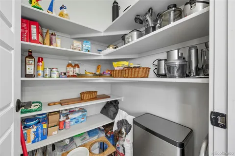 a storage room with lots of clutter and cabinets
