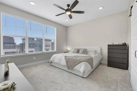 a spacious bedroom with a bed and a large window