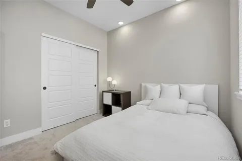 a bedroom with a bed and a night stand