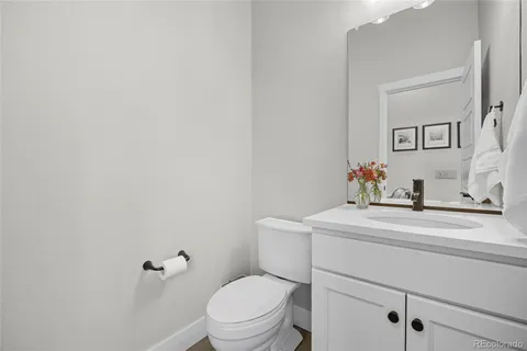 a bathroom with a sink toilet and mirror