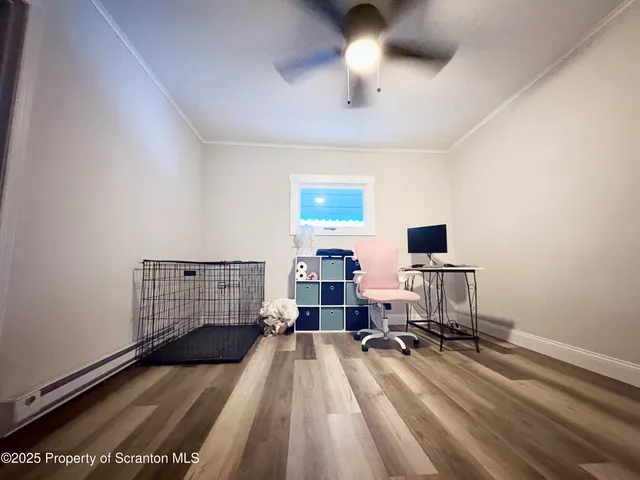 a view of a workspace with furniture and a window