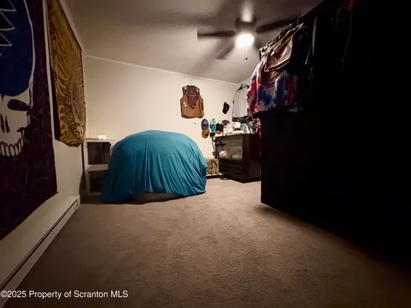 a bedroom with a bed and a ceiling fan
