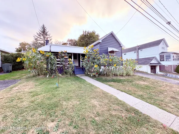 a view of a house next to a yard