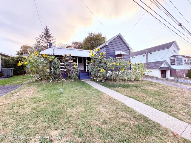 a view of a house next to a yard