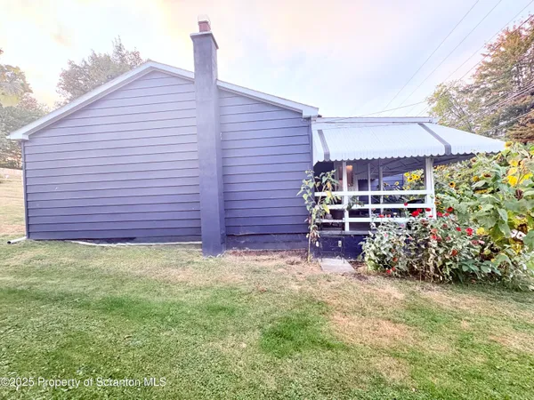 a wooden bench sitting in front of a house
