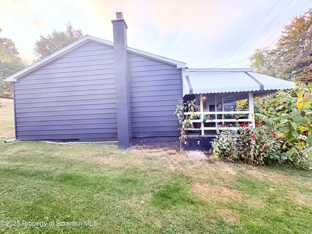 a wooden bench sitting in front of a house