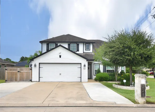 a front view of a house with garage and yard