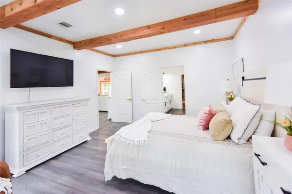 a bedroom with a bed and a flat screen tv