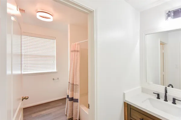 a bathroom with a toilet and a shower curtain