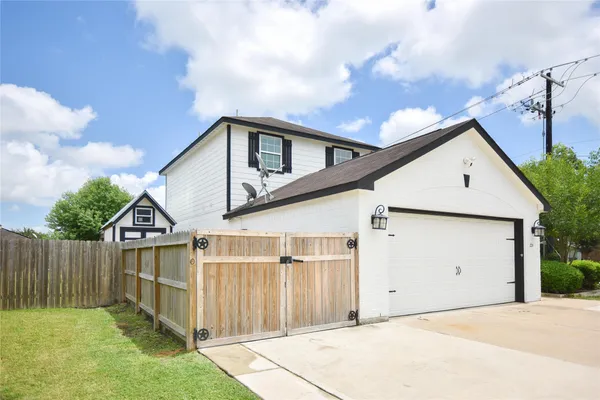 a view of a house with wooden fence