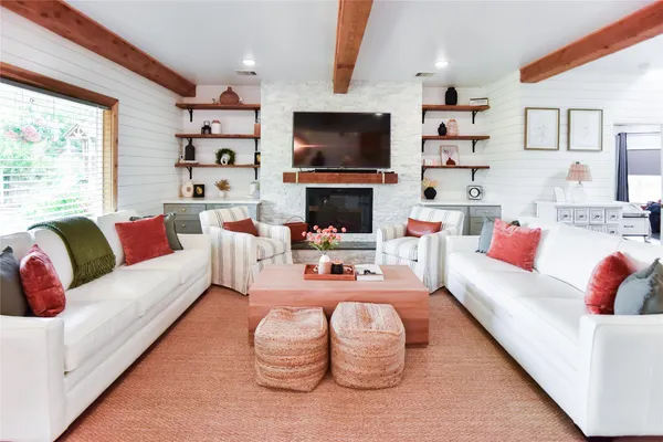 a living room with fireplace furniture and a flat screen tv