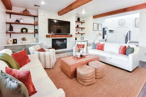 a living room with furniture fireplace and flat screen tv