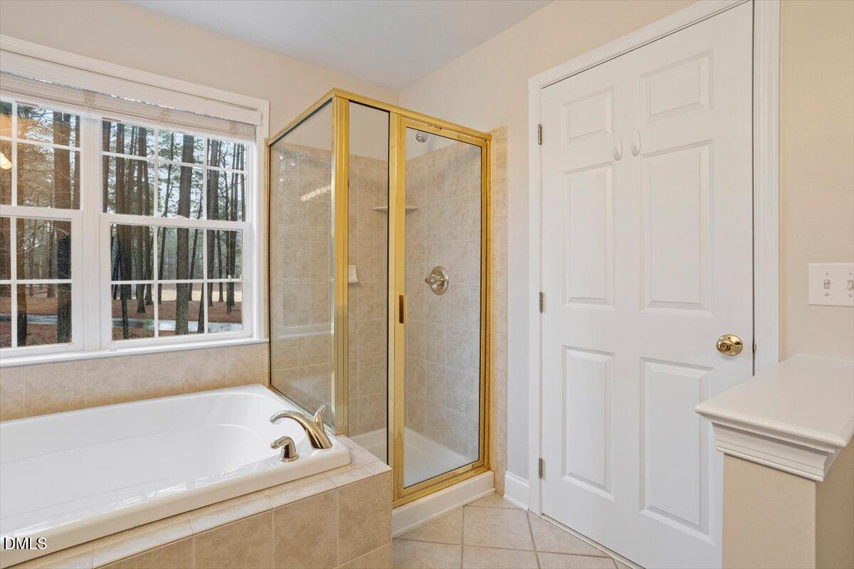 11213 Maplecroft Court Raleigh, NC 27617 - Photo 11 of 44 a bathroom with a bathtub and a shower