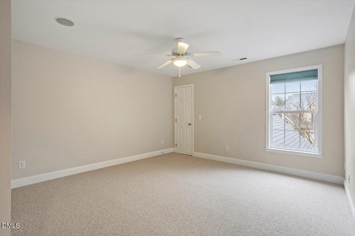 11213 Maplecroft Court Raleigh, NC 27617 - Photo 21 of 44 an empty room with windows and fan