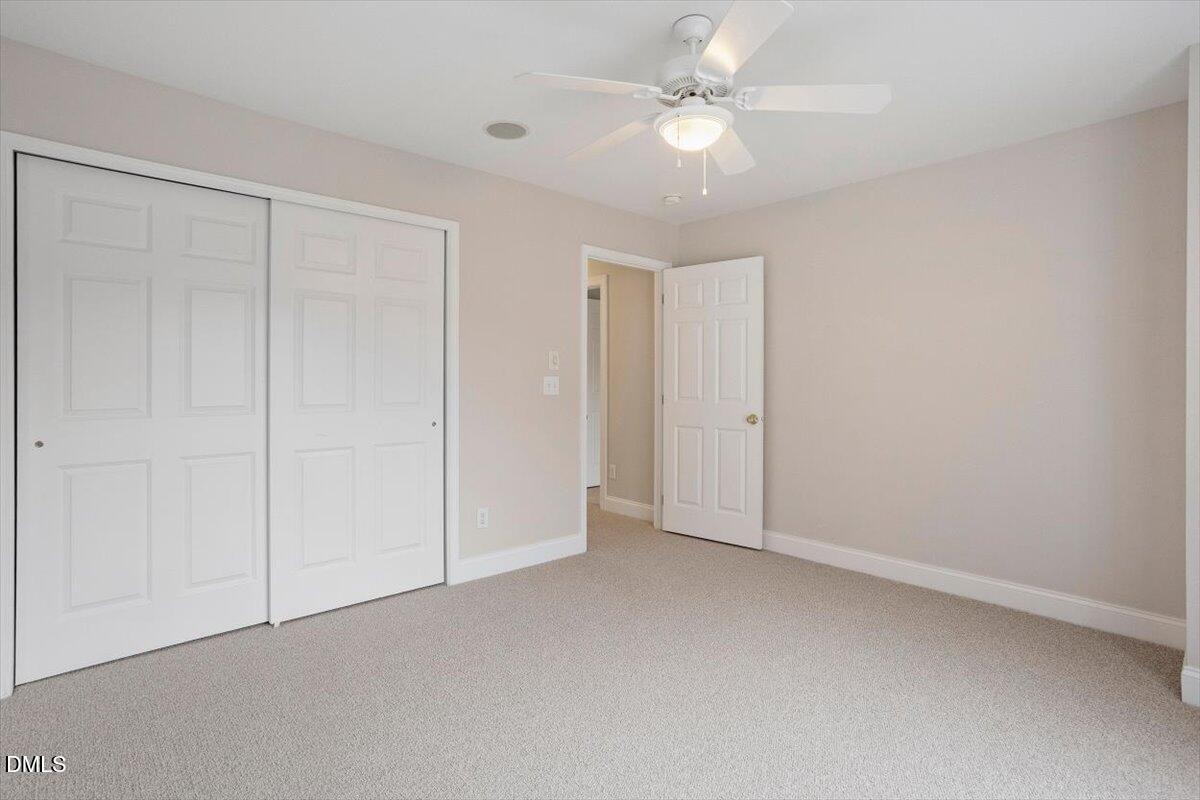 11213 Maplecroft Court Raleigh, NC 27617 - Photo 24 of 44 an empty room with a ceiling fan and a window