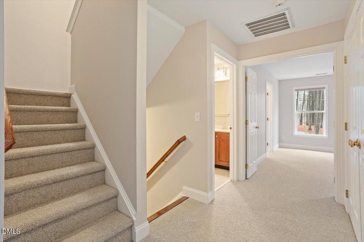 11213 Maplecroft Court Raleigh, NC 27617 - Photo 25 of 44 a view of a hallway with staircase