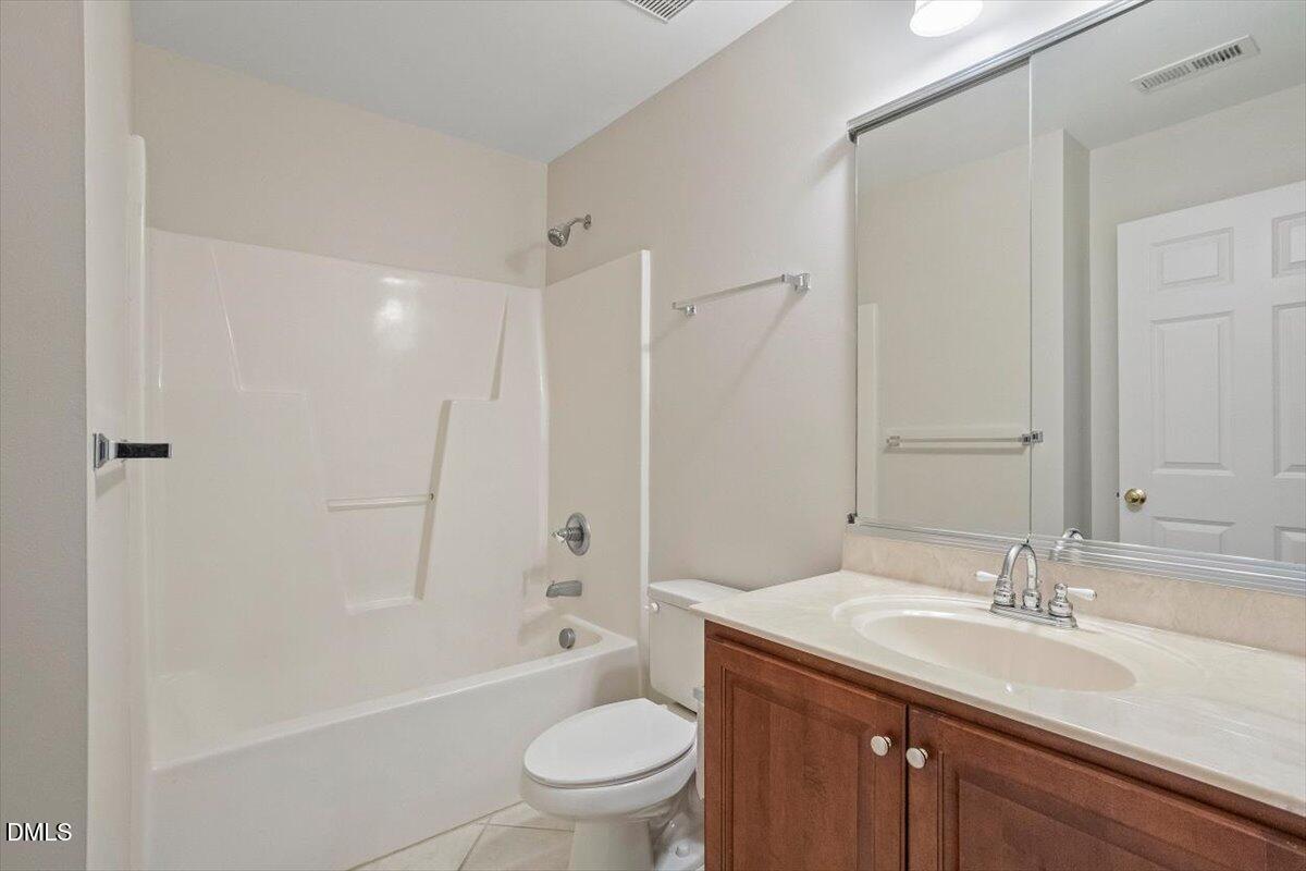 11213 Maplecroft Court Raleigh, NC 27617 - Photo 26 of 44 a bathroom with a granite countertop sink a toilet and shower