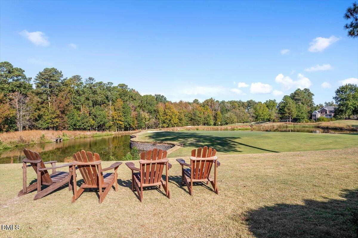 11213 Maplecroft Court Raleigh, NC 27617 - Photo 42 of 44 a view of a lake with table and chairs