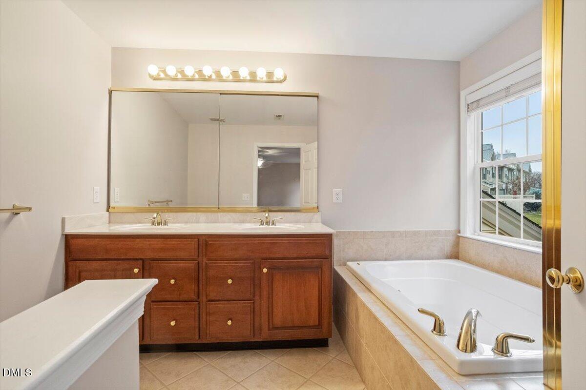 11213 Maplecroft Court Raleigh, NC 27617 - Photo 10 of 44 a spacious bathroom with a tub sink and mirror