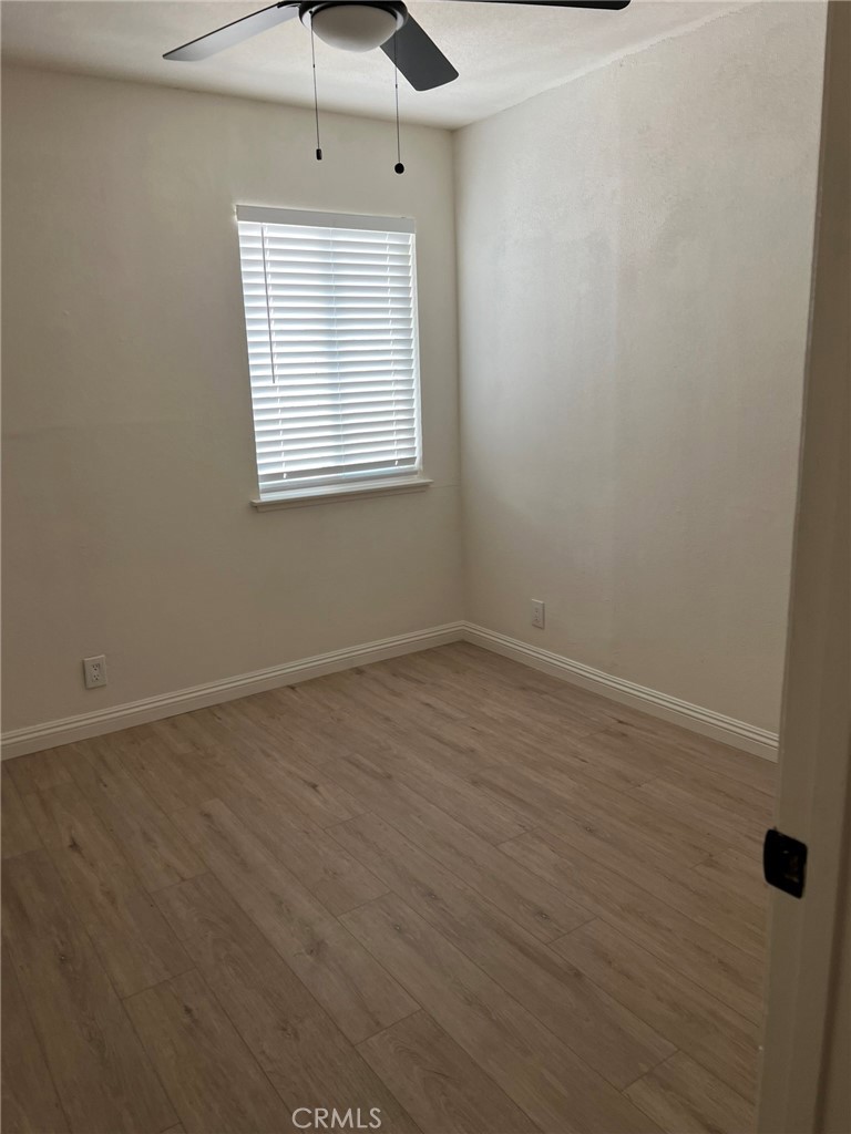 37920 Grandview Avenue Yermo, CA 92398 - Photo 11 of 11 wooden floor in an empty room with a window