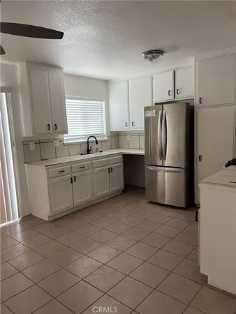 a kitchen with stainless steel appliances a refrigerator sink and cabinets