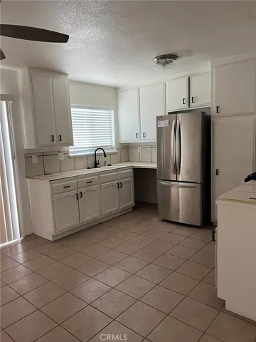 a kitchen with stainless steel appliances a refrigerator sink and cabinets