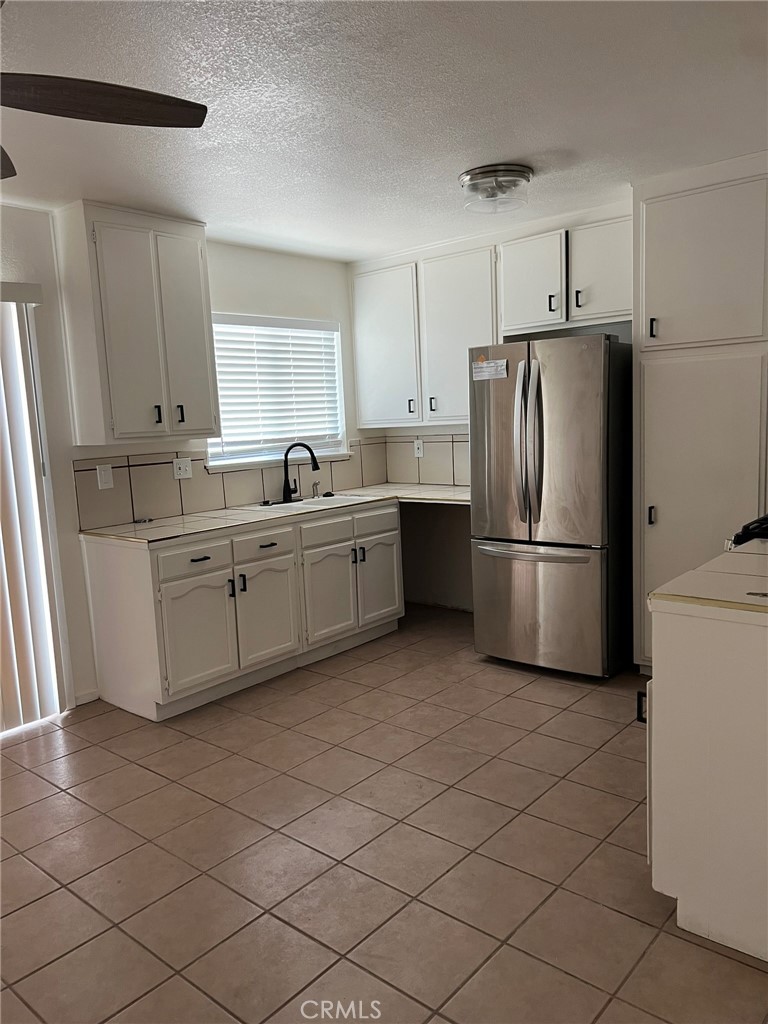 37920 Grandview Avenue Yermo, CA 92398 - Photo 4 of 11 a kitchen with stainless steel appliances a refrigerator sink and cabinets