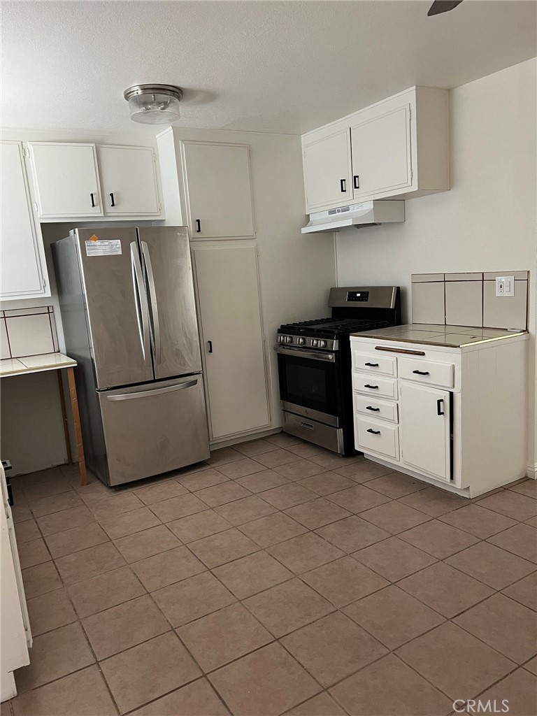 37920 Grandview Avenue Yermo, CA 92398 - Photo 5 of 11 a kitchen with stainless steel appliances granite countertop a refrigerator sink and stove