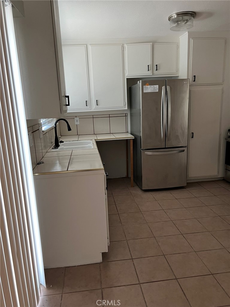 37920 Grandview Avenue Yermo, CA 92398 - Photo 6 of 11 a kitchen with a sink a refrigerator and cabinets