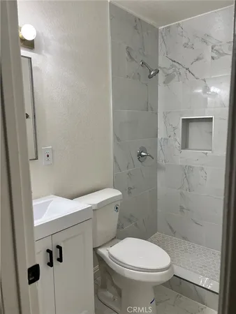 a white toilet sitting next to a bathroom sink