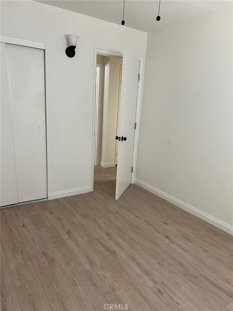 37920 Grandview Avenue Yermo, CA 92398 - Photo 9 of 11 a view of an empty room with wooden floor