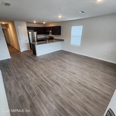 a view of a kitchen with a sink and a microwave