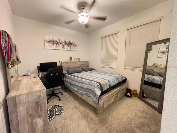 a bedroom with a bed and a chandelier