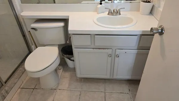 a bathroom with a sink vanity mirror and toilet