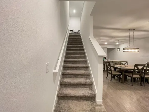 a hallway with sliding door and stairs