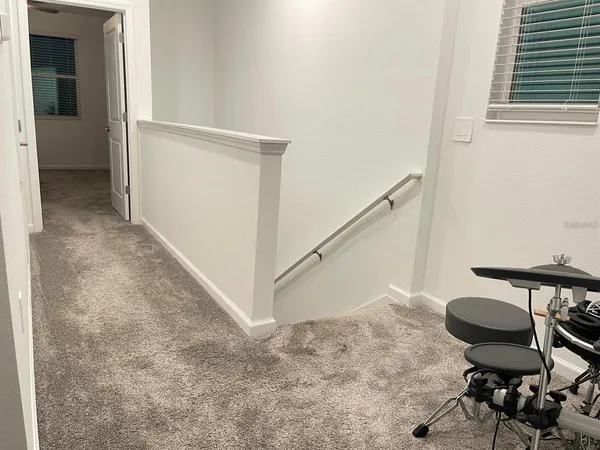 a bed room with a bed and a painting on the wall