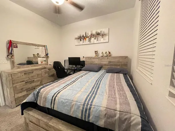 a bedroom with a bed and a fireplace