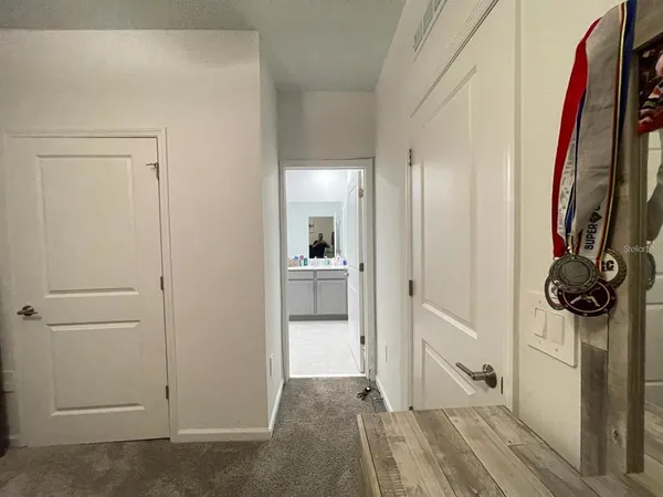 a bed sitting in a bedroom next to a window